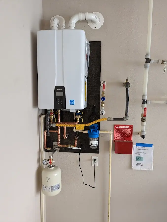 Professional plumber installing copper piping in a Defiance home